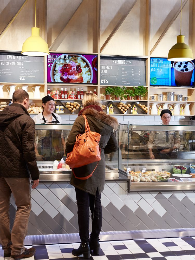 Customers queue at the hot food bar in Centra's new store format designed by creative agency Household.