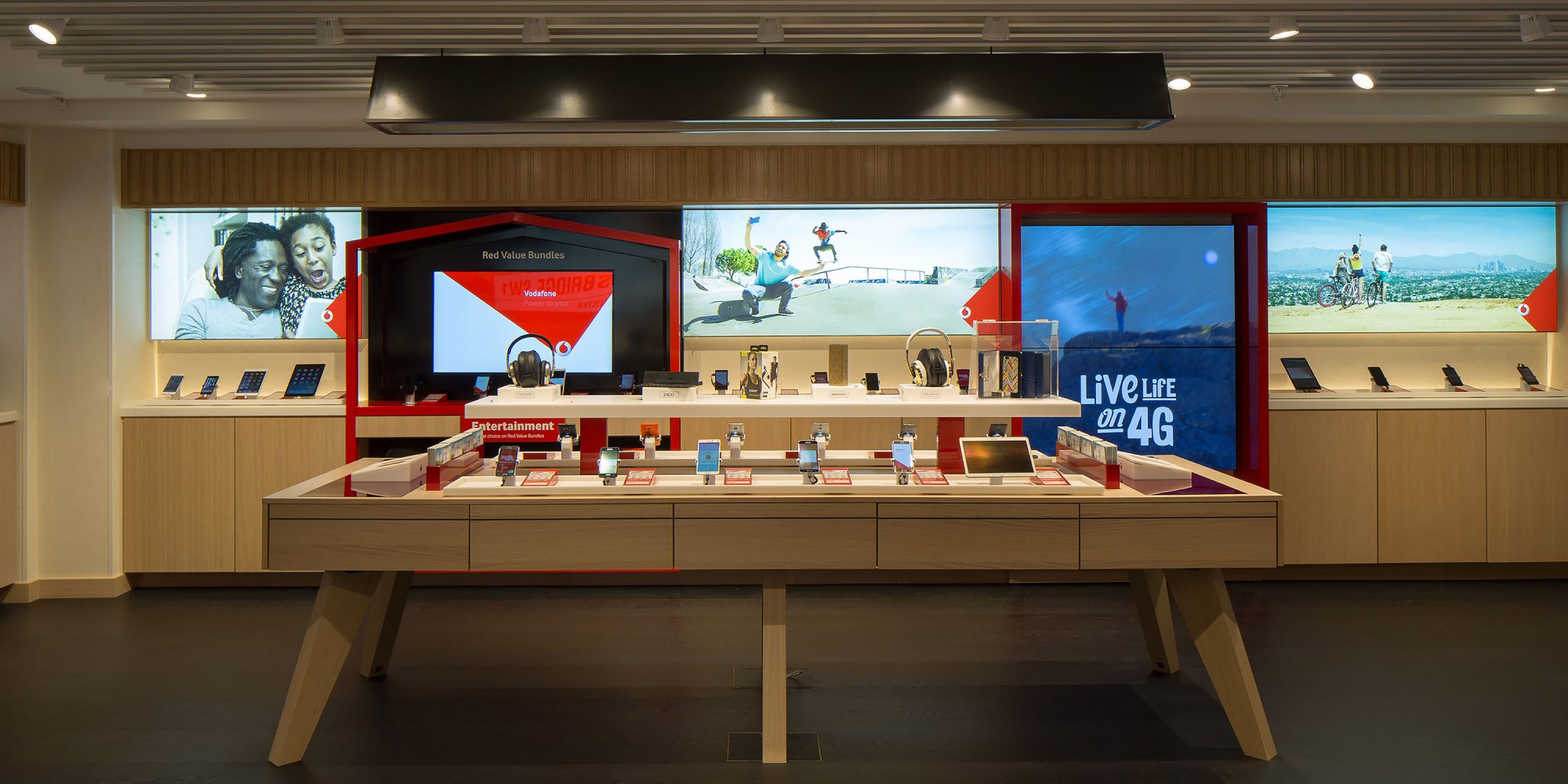 Vodafone Harrods interior image of store showing wall display and midfloor unit, Luxury Retail Experience Design by Household.
